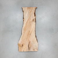 Large wooden slab in a workshop setting with tools and equipment around view 1