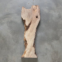 Large wooden sculpture of a whale in a workshop setting view 1
